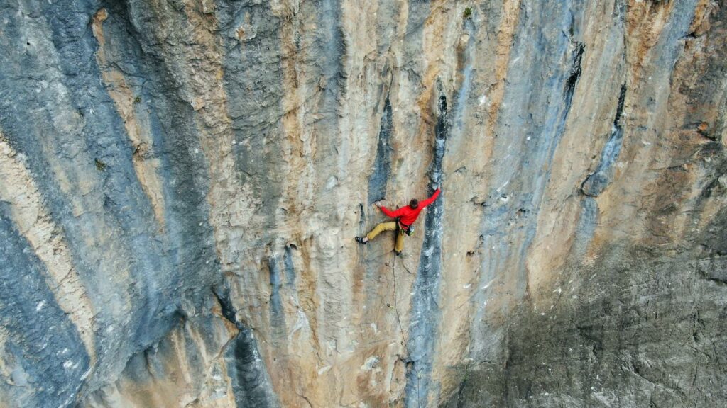 A fearless rock climber conquers a steep cliff face in Leonidio, Greece.