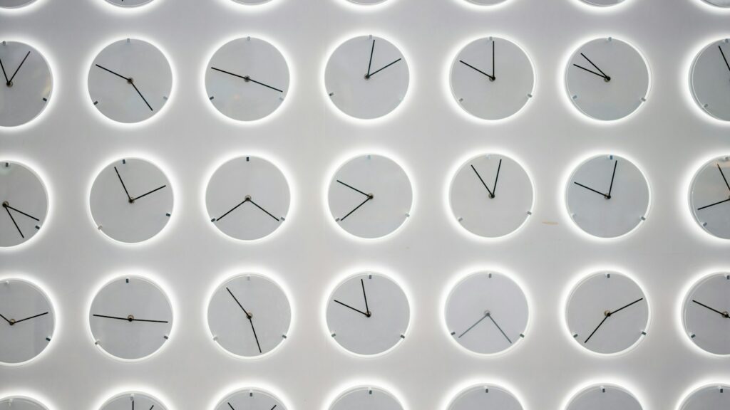a white wall with many clocks on it