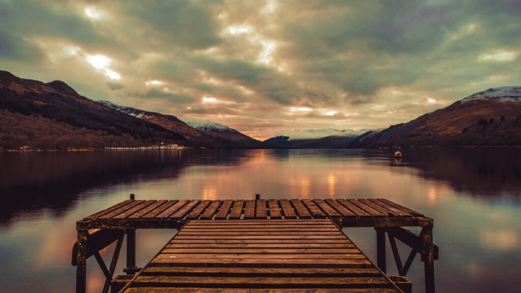 brown wooden dock on lake during daytime